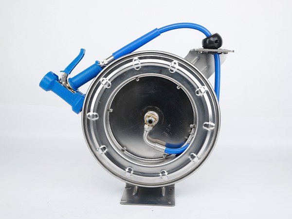 A hose reel with a blue hose and nozzle.