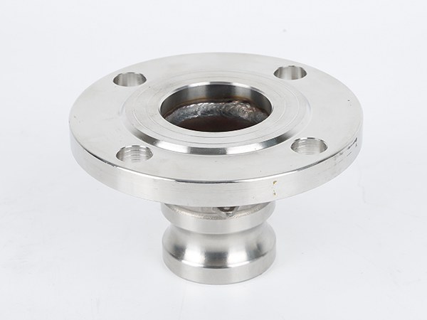 A male camlock on flange facing upwards.